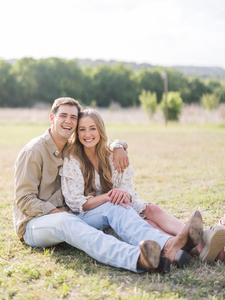 A casual white dress pairs well with boots and jeans for an engagement shoot.